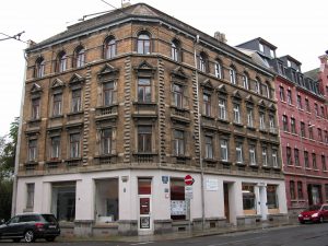 Four-storey victorian era corner building with two stores in the ground floor in Leipzig